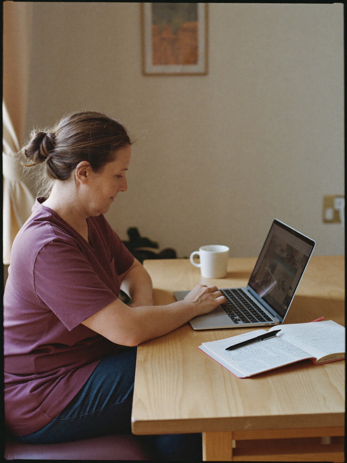 A midwife studying the online course at her desk